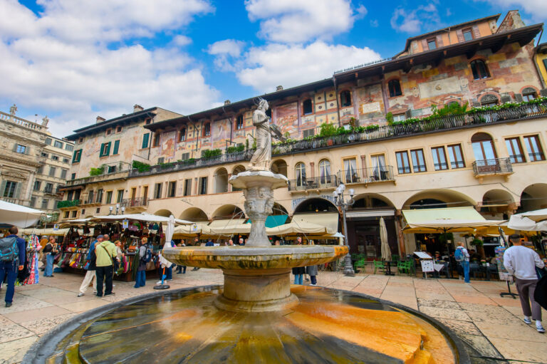 Verona, Italy - 18.10.2024: Madonna Verona Fountain in front of Case dei Mazzanti on Piazza delle Erbe